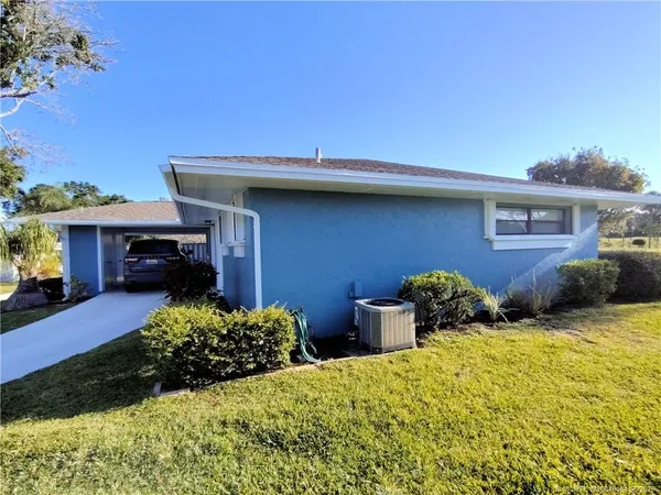 a view of a dining room with furniture and a window
