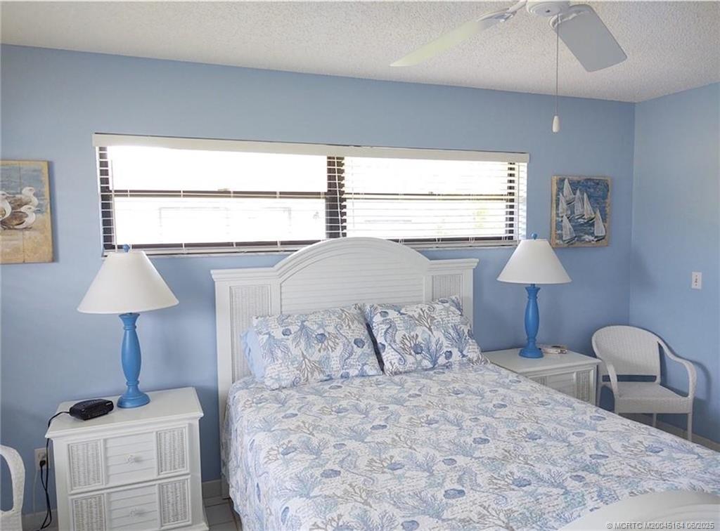 Undisclosed Address Stuart, FL 34997 - Photo 29 of 81 a bedroom with a bed and a lamp