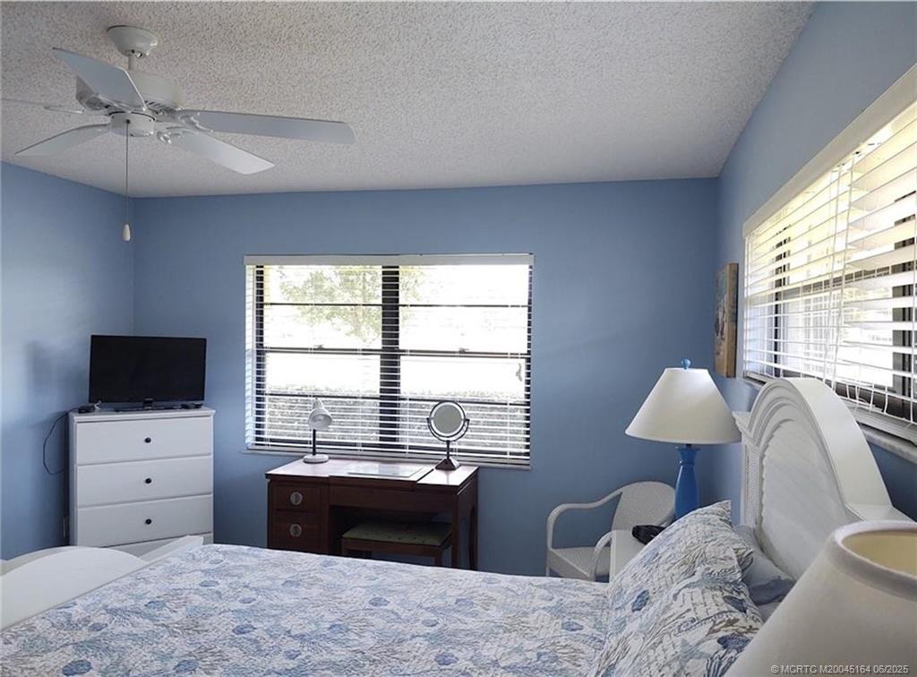 Undisclosed Address Stuart, FL 34997 - Photo 35 of 81 a bedroom with a bed and a flat screen tv