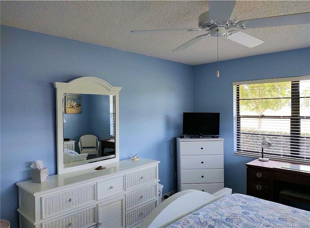 Undisclosed Address Stuart, FL 34997 - Photo 36 of 81 a bedroom with a bed and a flat screen tv