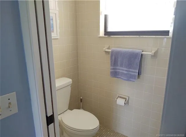 a view of a porch with chairs and couches with wooden floor