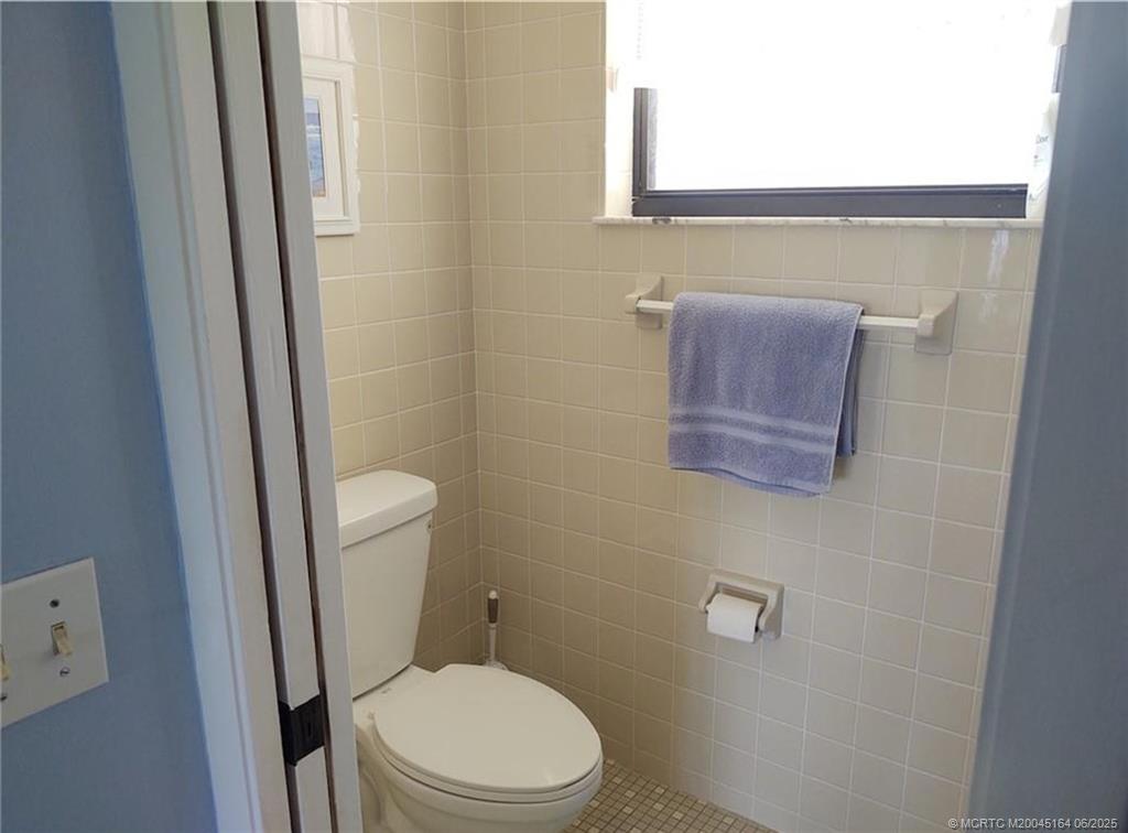 Undisclosed Address Stuart, FL 34997 - Photo 39 of 81 a white toilet sitting next to a small sink