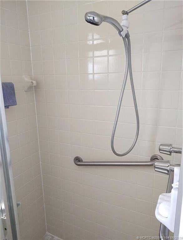 Undisclosed Address Stuart, FL 34997 - Photo 40 of 81 a bathroom with a shower and a mirror