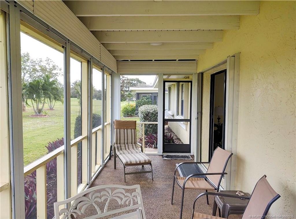 Undisclosed Address Stuart, FL 34997 - Photo 55 of 81 a view of a porch with chairs and couches with wooden floor