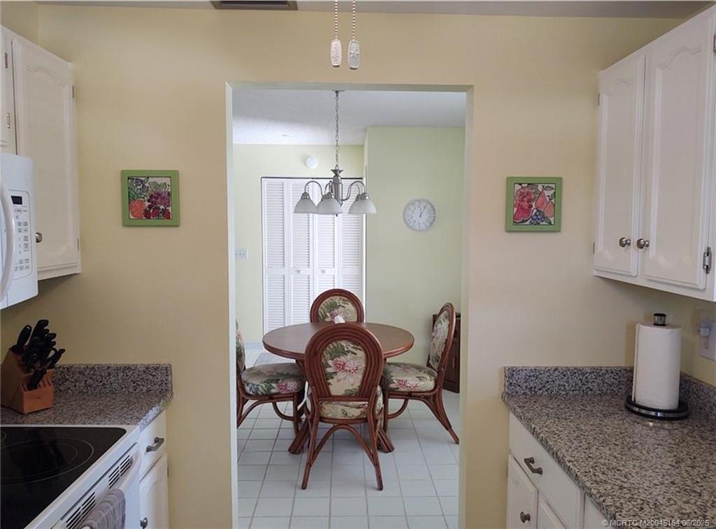 Undisclosed Address Stuart, FL 34997 - Photo 6 of 81 a kitchen with granite countertop a sink cabinets and stove top oven