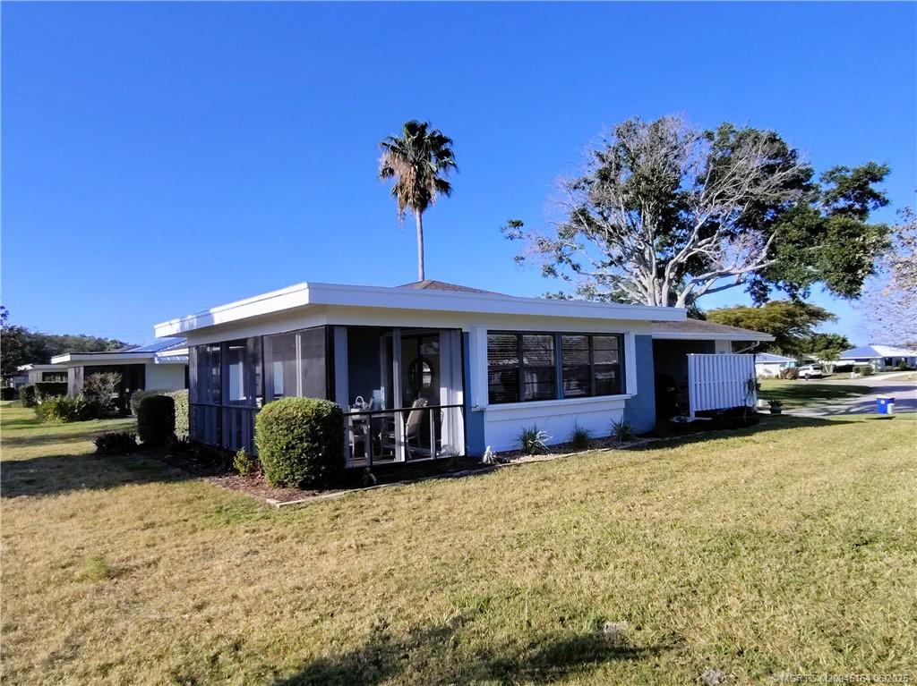 Undisclosed Address Stuart, FL 34997 - Photo 67 of 81 a view of a house with a yard and potted plants