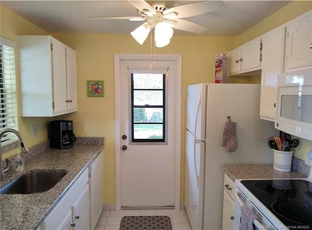 a bathroom with a granite countertop sink a mirror and a shower