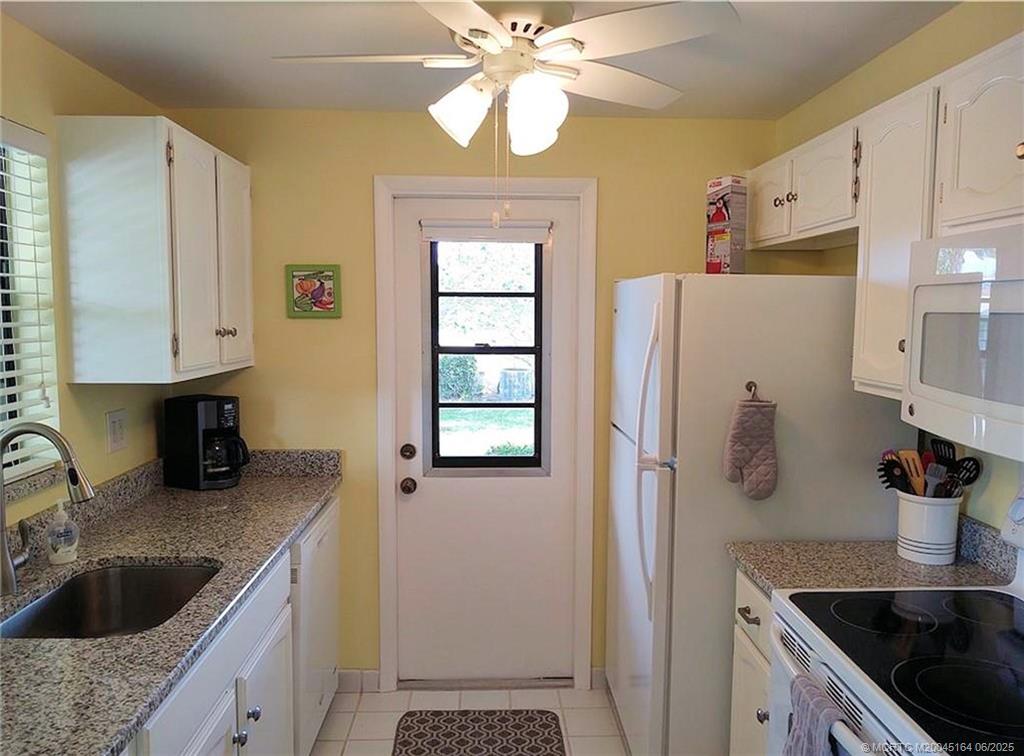 Undisclosed Address Stuart, FL 34997 - Photo 7 of 81 a kitchen with stainless steel appliances granite countertop a sink stove and refrigerator