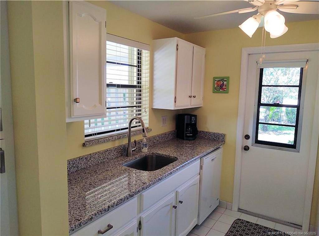 Undisclosed Address Stuart, FL 34997 - Photo 8 of 81 a kitchen with stainless steel appliances granite countertop a sink and a window