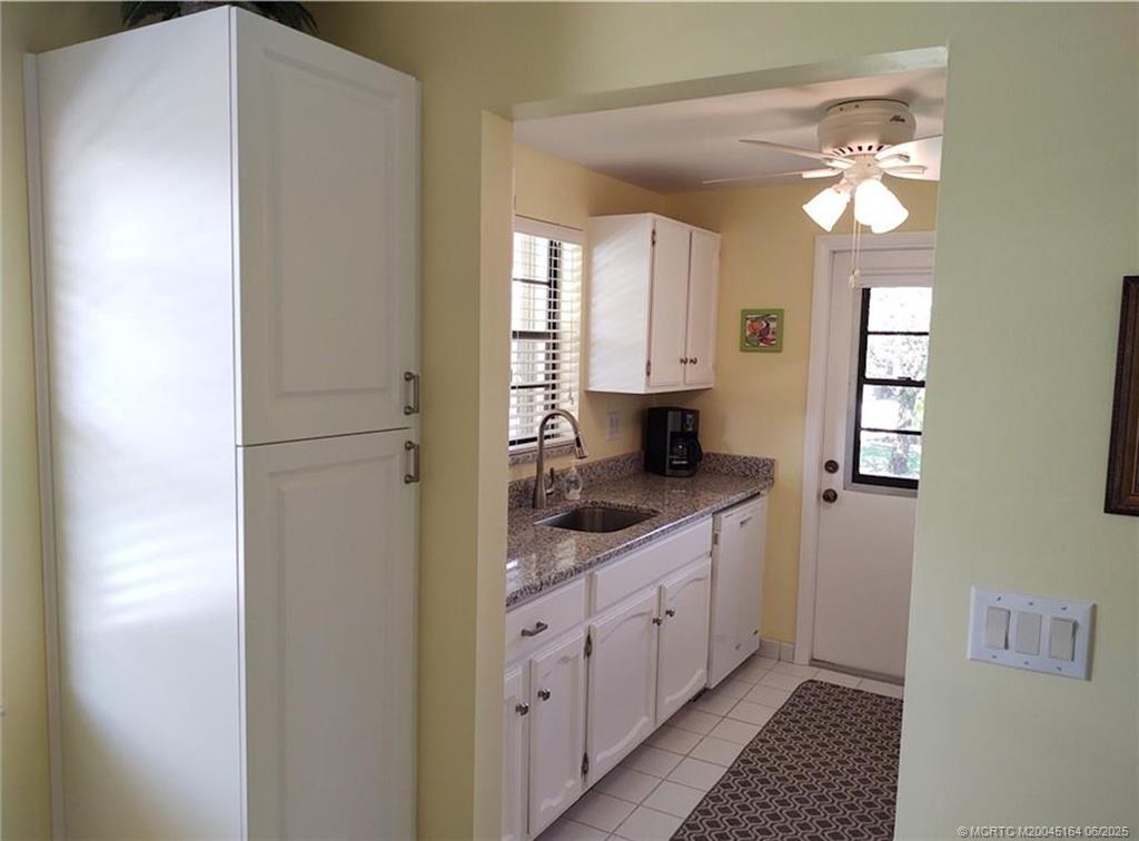 Undisclosed Address Stuart, FL 34997 - Photo 10 of 81 a bathroom with a granite countertop sink a mirror and a shower