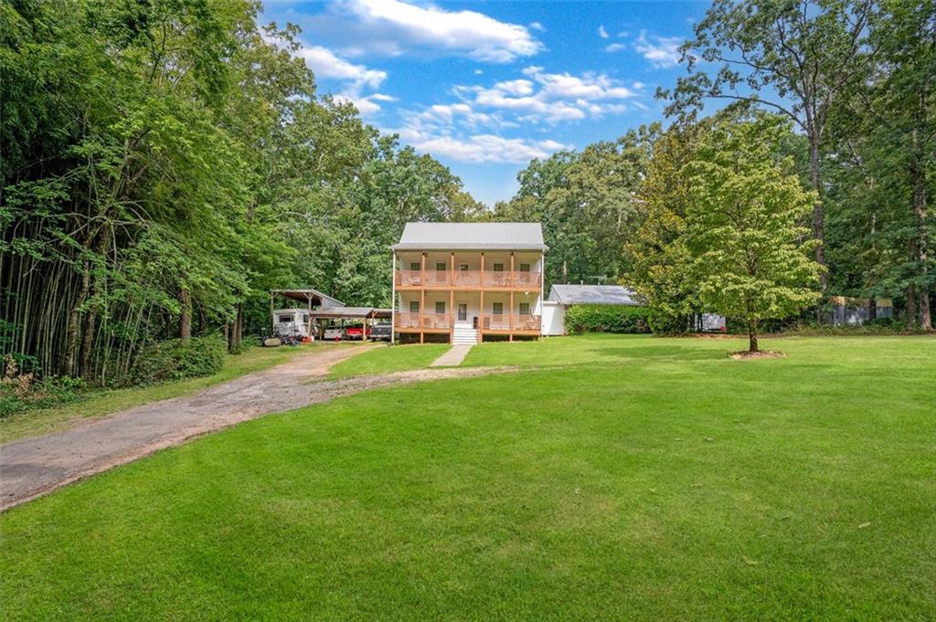 5364 Post Road Cumming, GA 30040 - Photo 12 of 12 a view of an house with backyard and trees