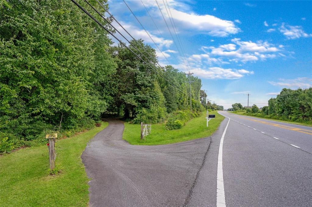 5364 Post Road Cumming, GA 30040 - Photo 3 of 12 a view of a street with a yard