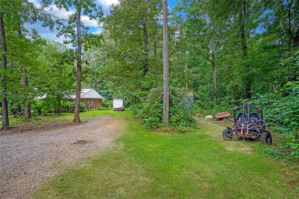 5364 Post Road Cumming, GA 30040 - Photo 9 of 12 a view of a backyard with a bench
