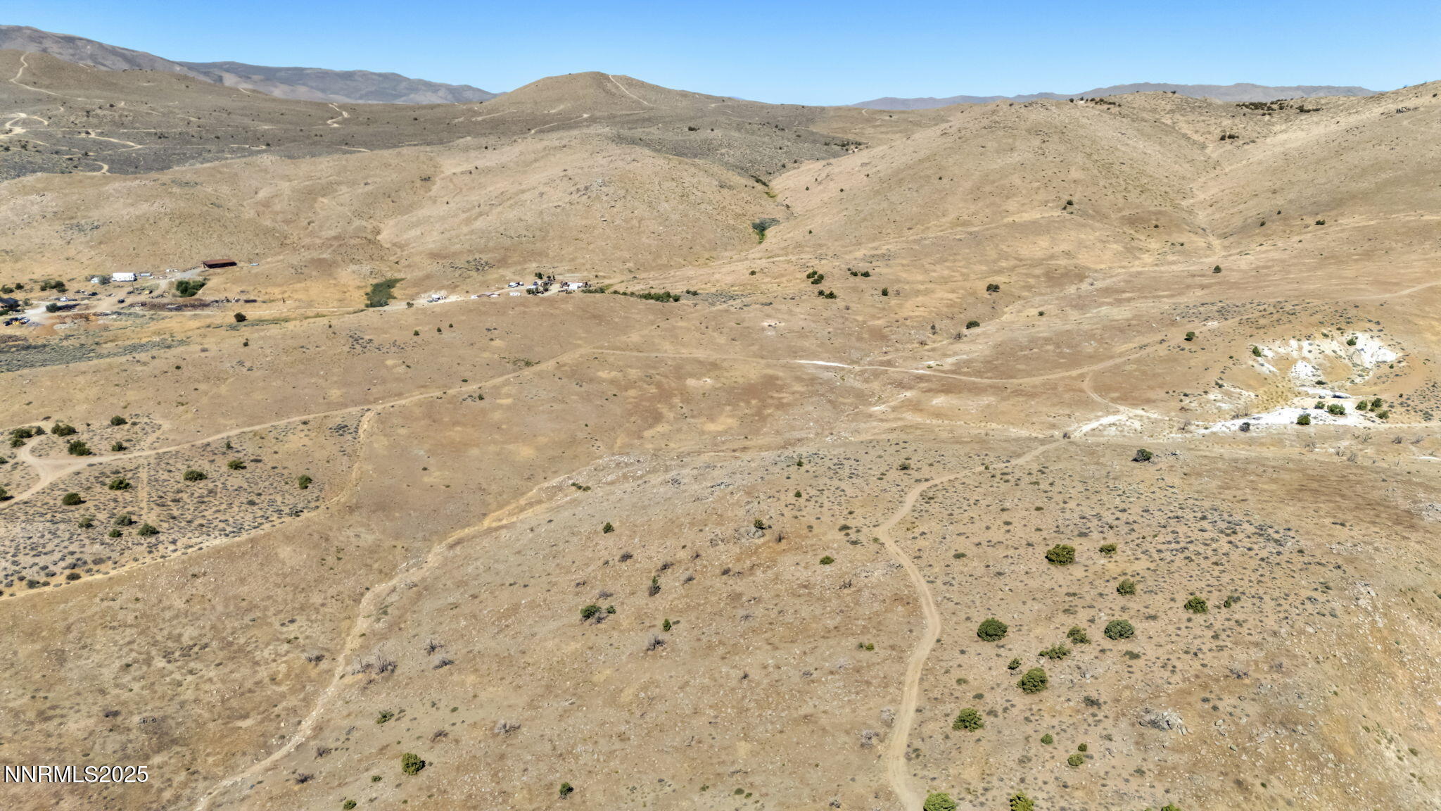 8560 Chimney Road, Unit GOOGLE MAPS IS NOT ACCURATE Sparks, NV 89436 - Photo 12 of 46 a view of a dry field with mountains in the background