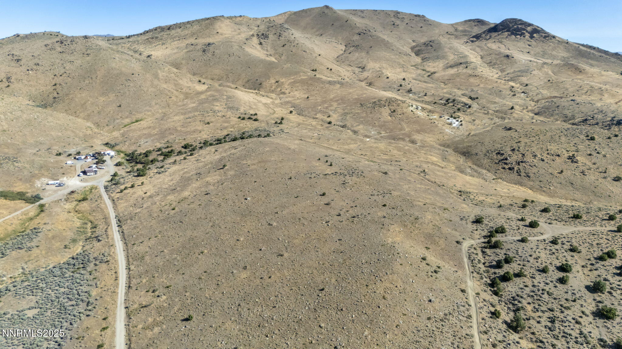 8560 Chimney Road, Unit GOOGLE MAPS IS NOT ACCURATE Sparks, NV 89436 - Photo 2 of 46 a view of a dry field with mountains in the background