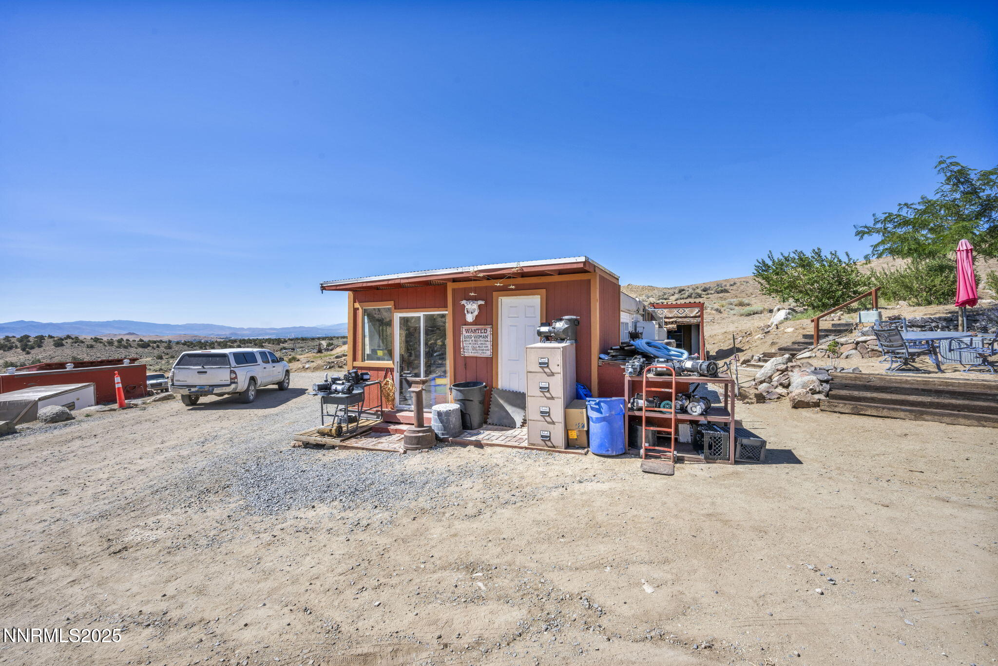 8560 Chimney Road, Unit GOOGLE MAPS IS NOT ACCURATE Sparks, NV 89436 - Photo 31 of 46 a view of a patio with a table and chairs under an umbrella