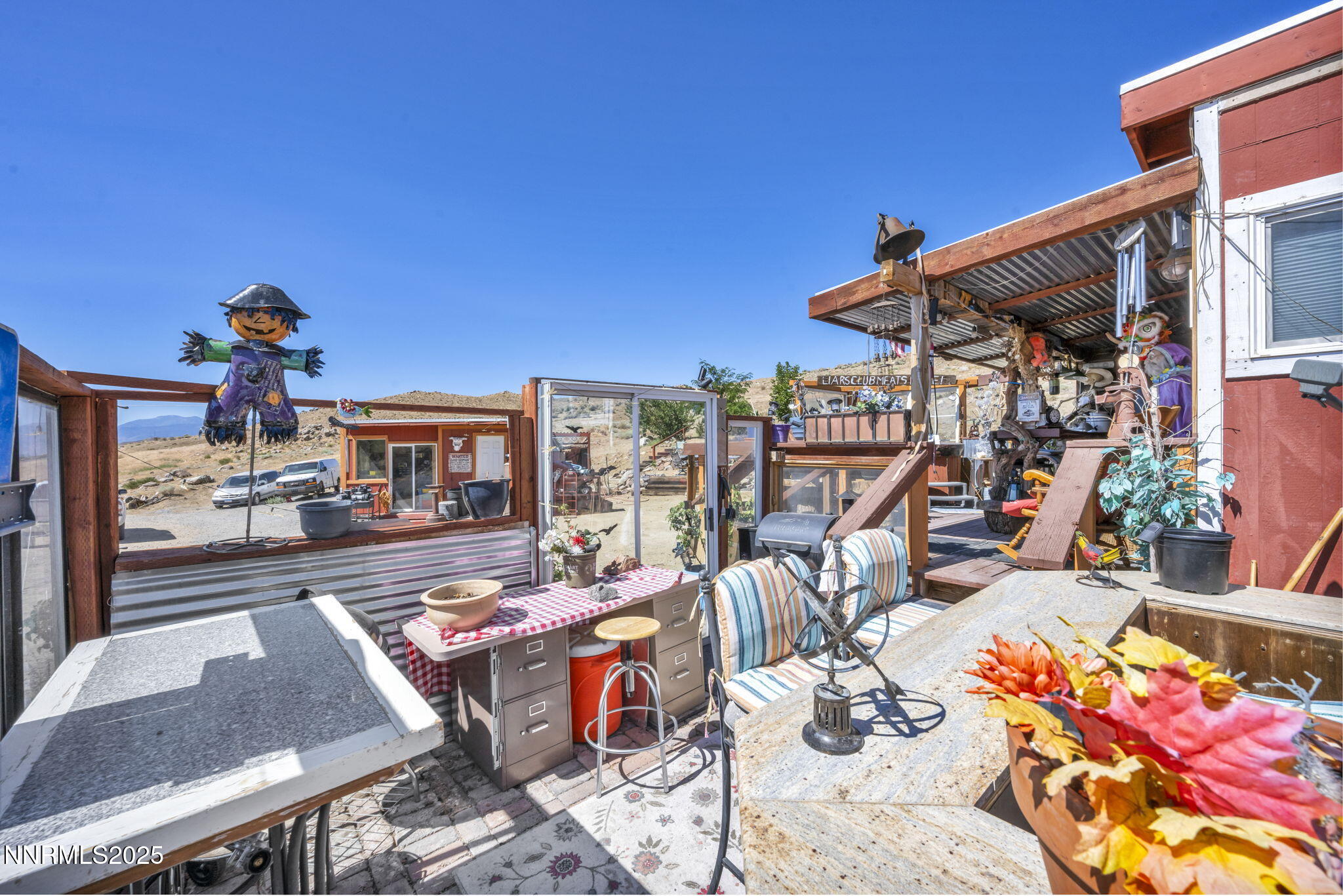 8560 Chimney Road, Unit GOOGLE MAPS IS NOT ACCURATE Sparks, NV 89436 - Photo 39 of 46 a view of a patio with table and chairs potted plants