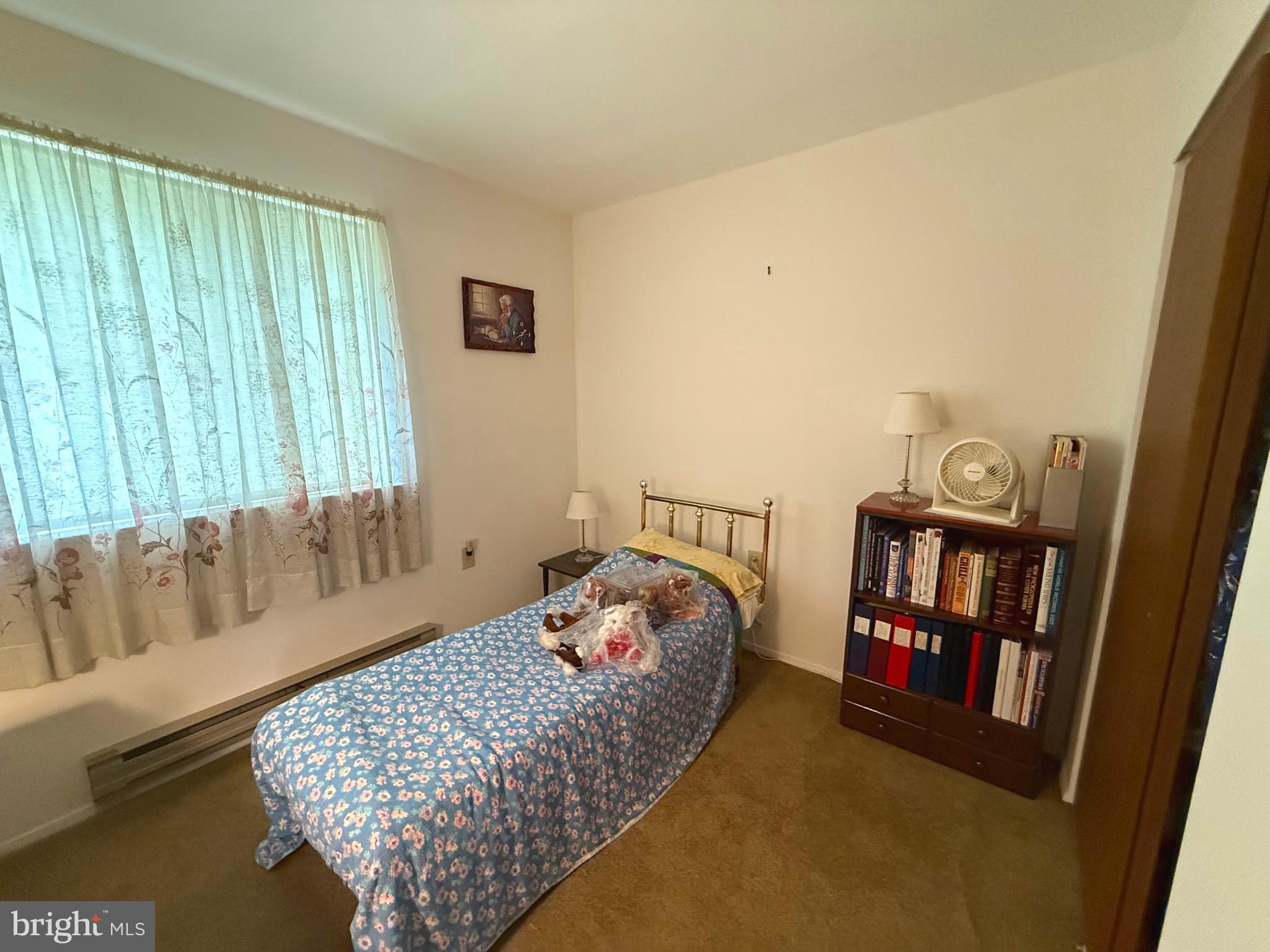16A Spring Street Manchester Township, NJ 08759 - Photo 11 of 20 a bedroom with a bed and a book shelf