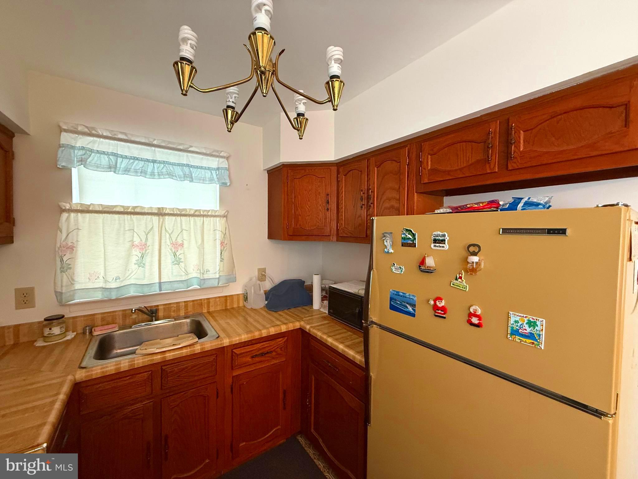16A Spring Street Manchester Township, NJ 08759 - Photo 7 of 20 a kitchen with a refrigerator a sink and cabinets