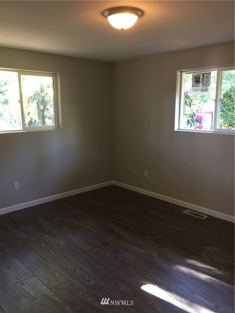2010 Northeast 27th Street Renton, WA 98056 - Photo 8 of 16 an empty room with wooden floor and windows