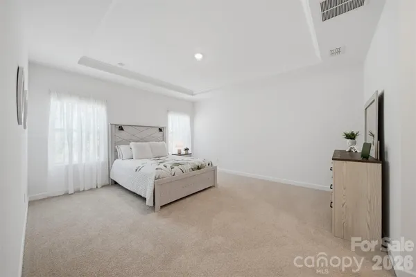 a room with a bed and a flat screen tv