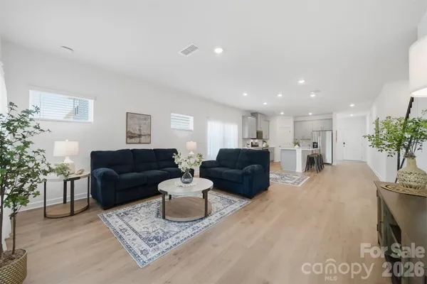 a living room with furniture and flowers