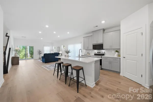 a kitchen with a sink a counter top space and stainless steel appliances
