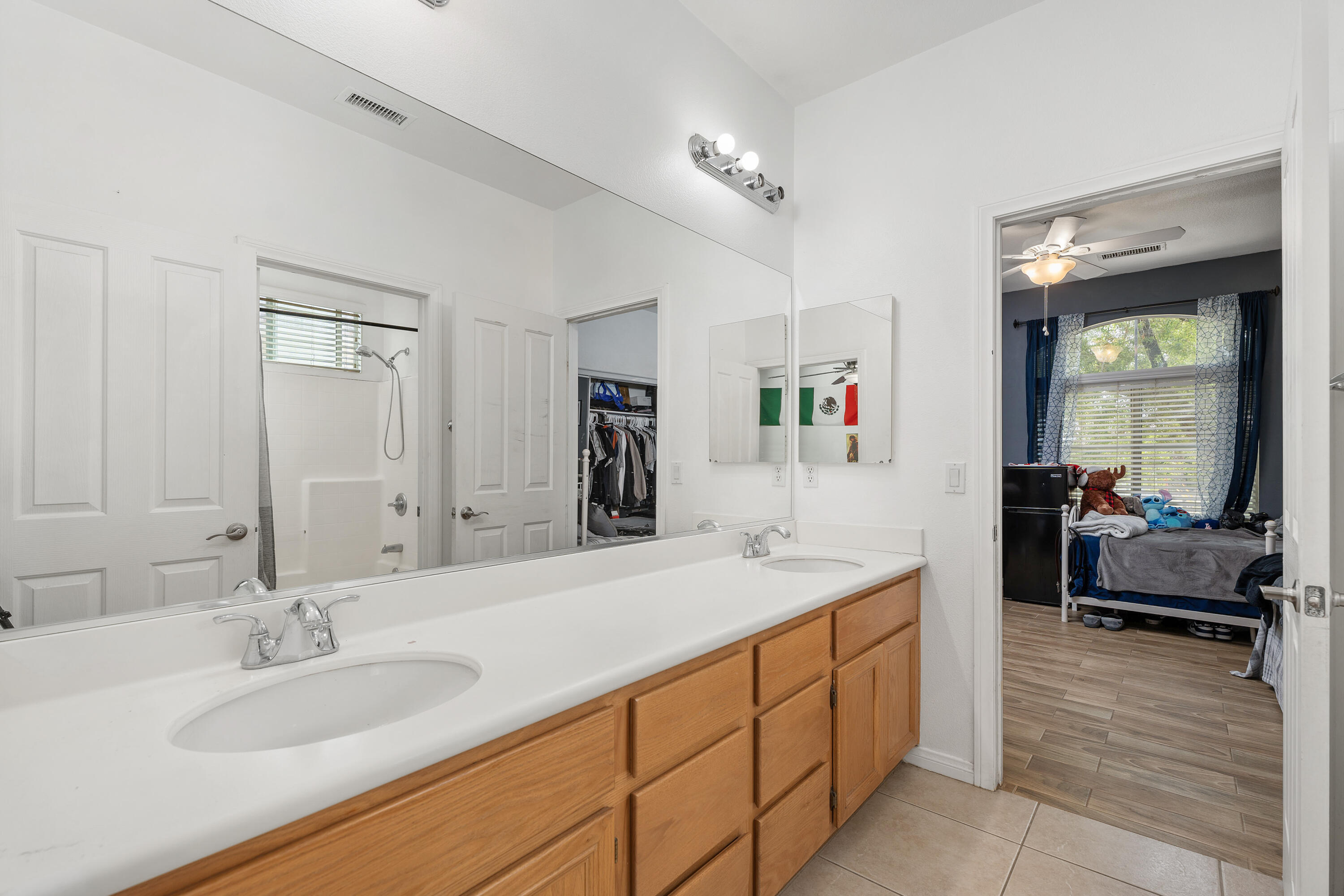 83814 Wolf Creek Road Indio, CA 92203 - Photo 17 of 28 a spacious bathroom with a granite countertop sink and a mirror