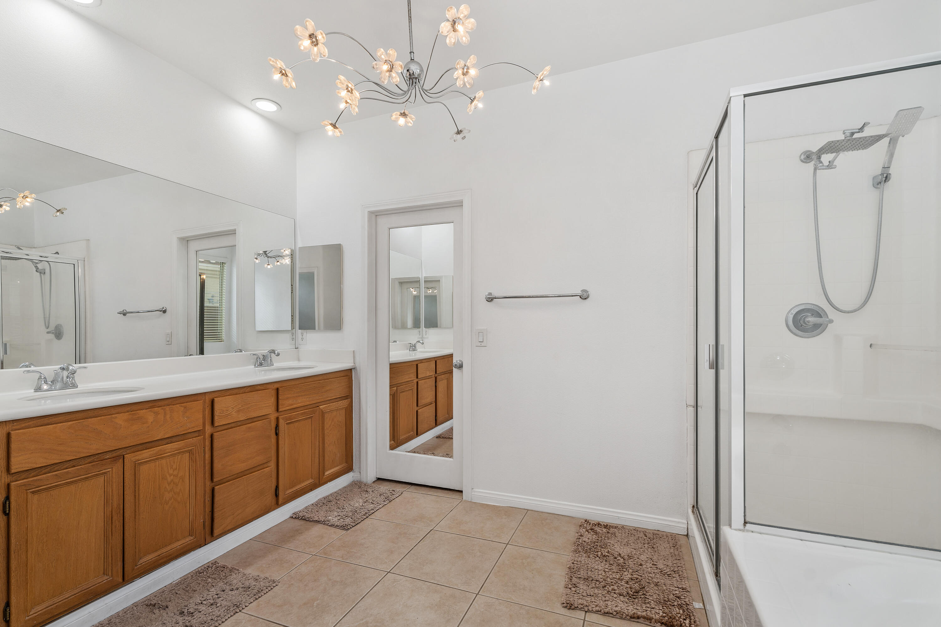 83814 Wolf Creek Road Indio, CA 92203 - Photo 21 of 28 a spacious bathroom with a mirror a shower and a sink