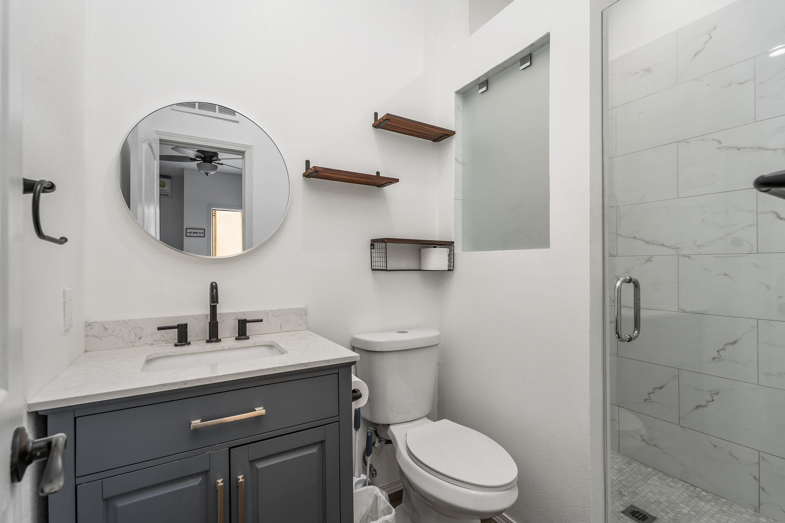 83814 Wolf Creek Road Indio, CA 92203 - Photo 24 of 28 a bathroom with a toilet sink and mirror