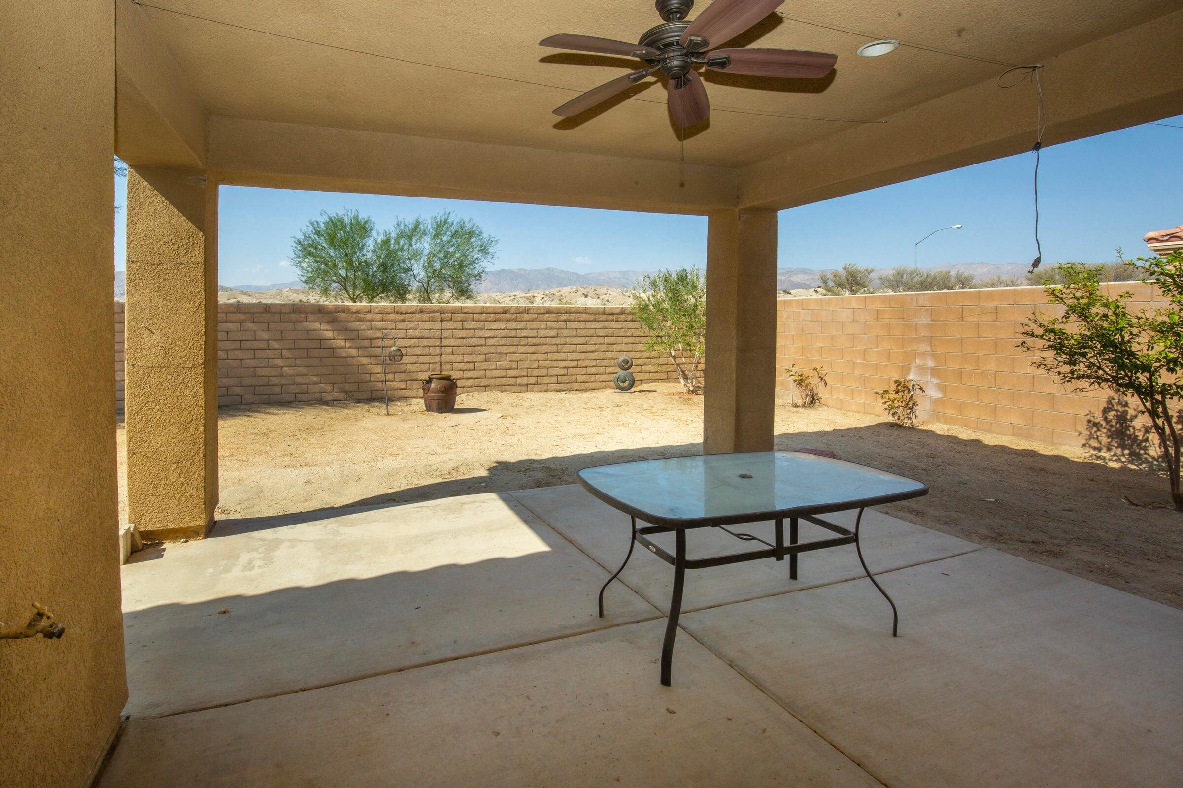 83814 Wolf Creek Road Indio, CA 92203 - Photo 27 of 28 a view of a balcony with table and chairs