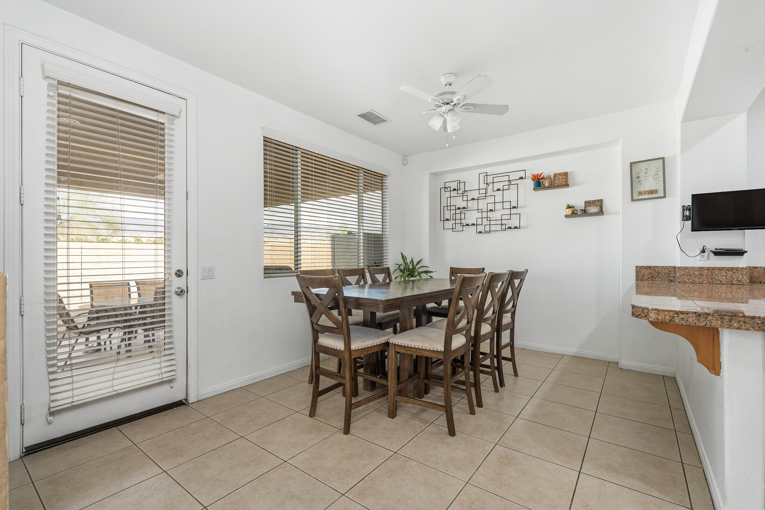83814 Wolf Creek Road Indio, CA 92203 - Photo 9 of 28 a view of a dining room with furniture and a chandelier