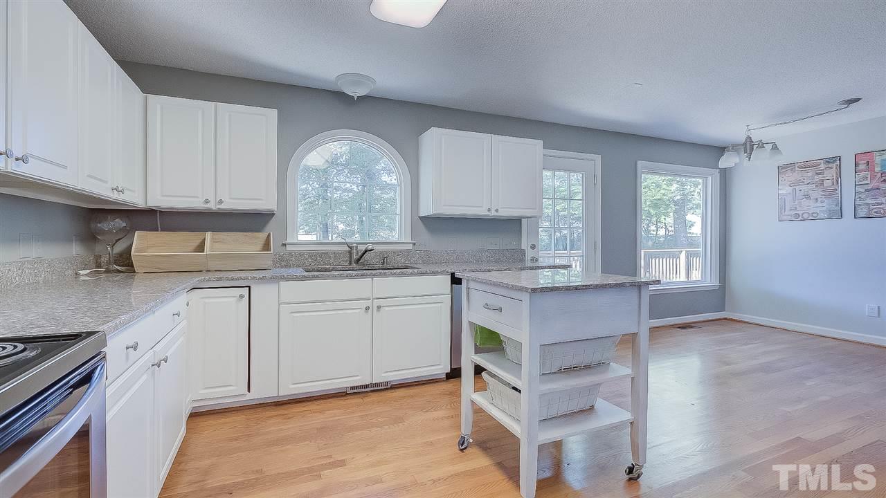 2041 Muirfield Village Way Raleigh, NC 27604 - Photo 5 of 25 Granite counters & lots of cabinets in kitchen. Plus, the cart with matching granite stays!