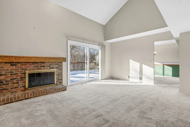 a view of a kitchen with a refrigerator a microwave and a sink