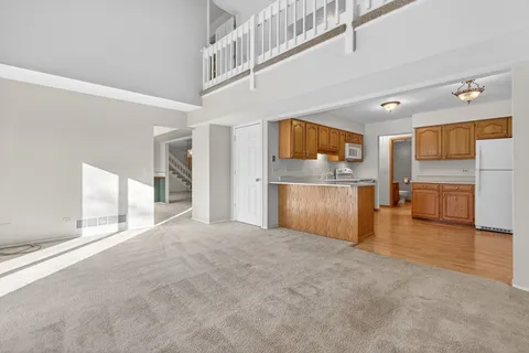 a kitchen with stainless steel appliances granite countertop a refrigerator sink stove and microwave