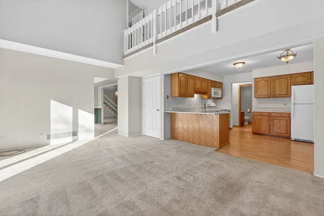 a kitchen with stainless steel appliances granite countertop a refrigerator sink stove and microwave