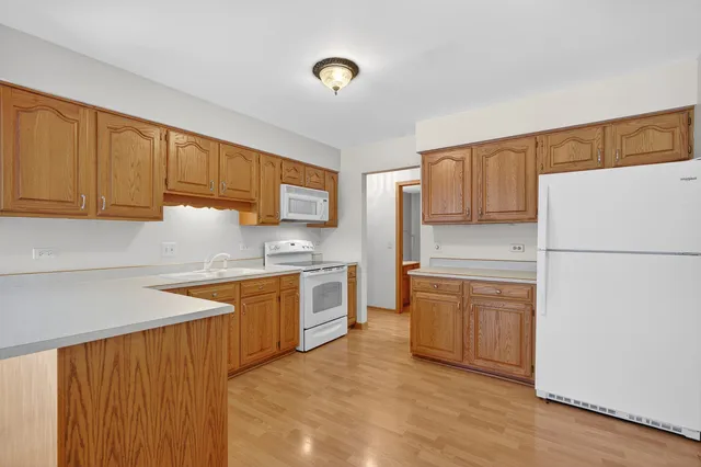 a kitchen with granite countertop wooden cabinets stainless steel appliances and a counter space