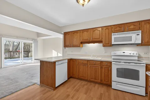a view of a kitchen with a sink a refrigerator and window