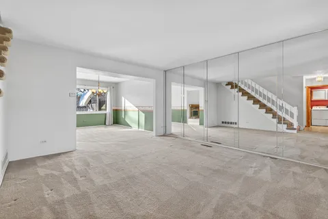 a view of empty room with a fireplace