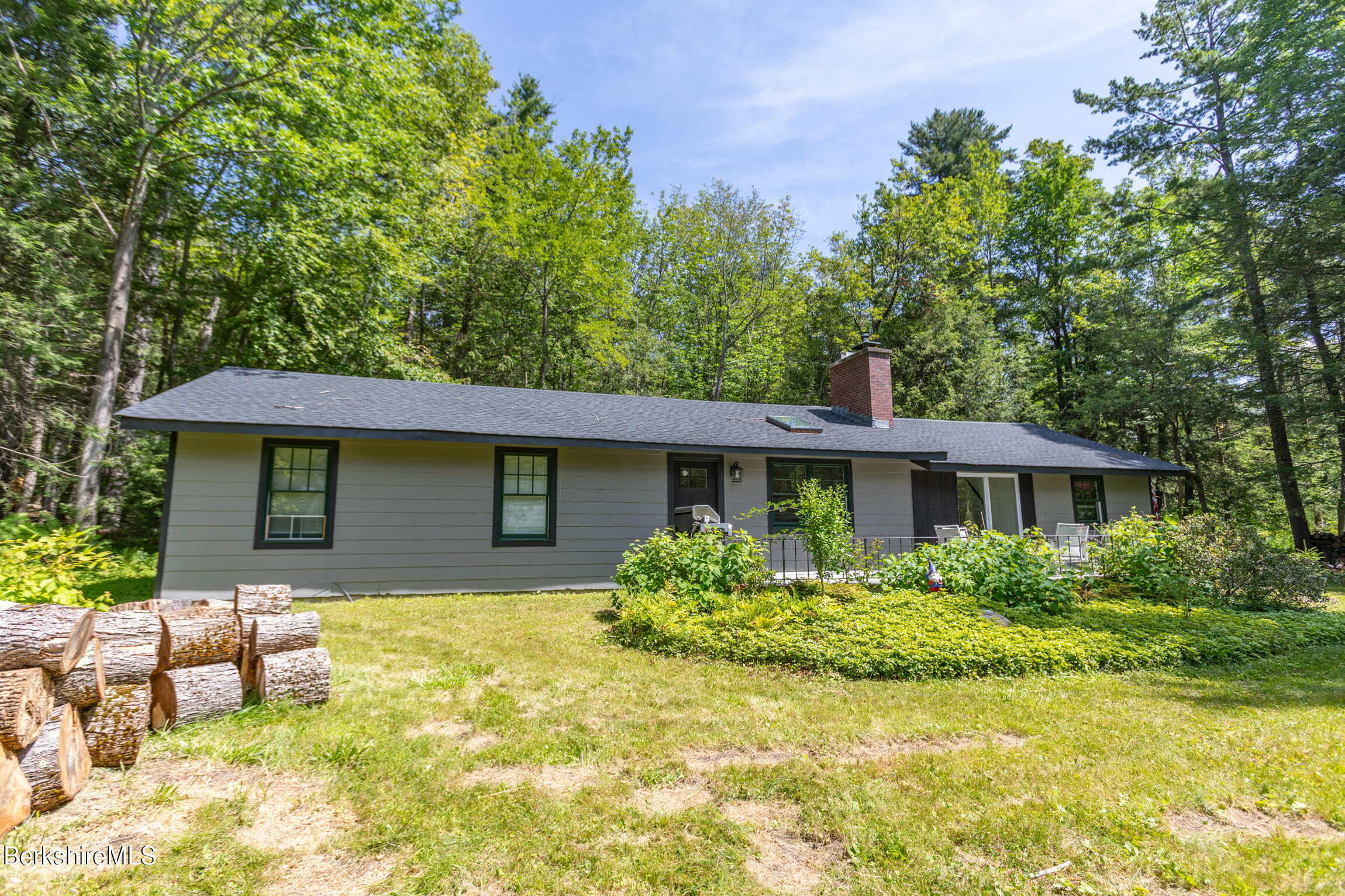 50 Beach Road Becket, MA 01223 - Photo 3 of 31 a front view of house with yard and trees around