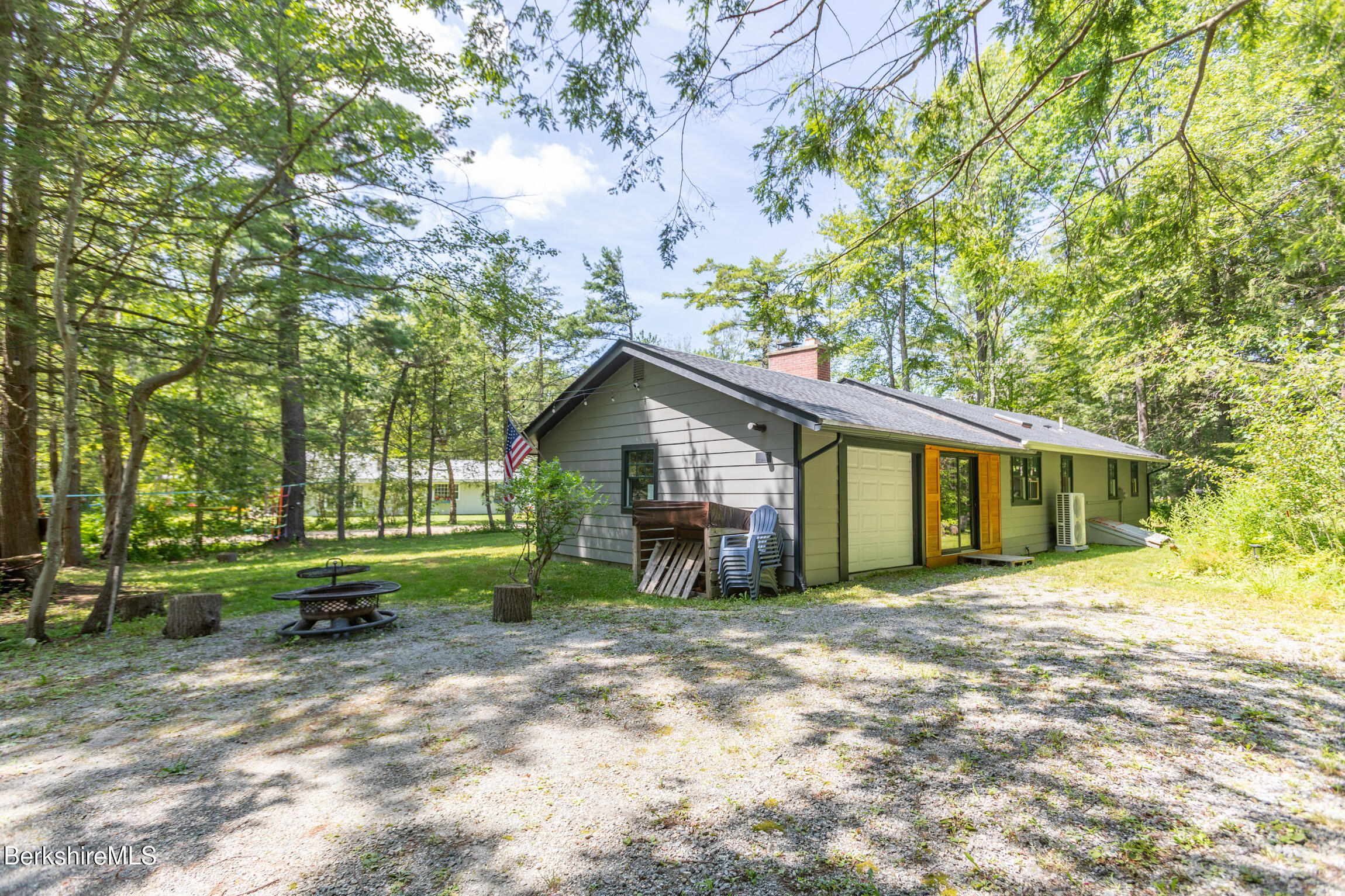 50 Beach Road Becket, MA 01223 - Photo 6 of 31 a backyard of a house with barbeque oven table and chairs