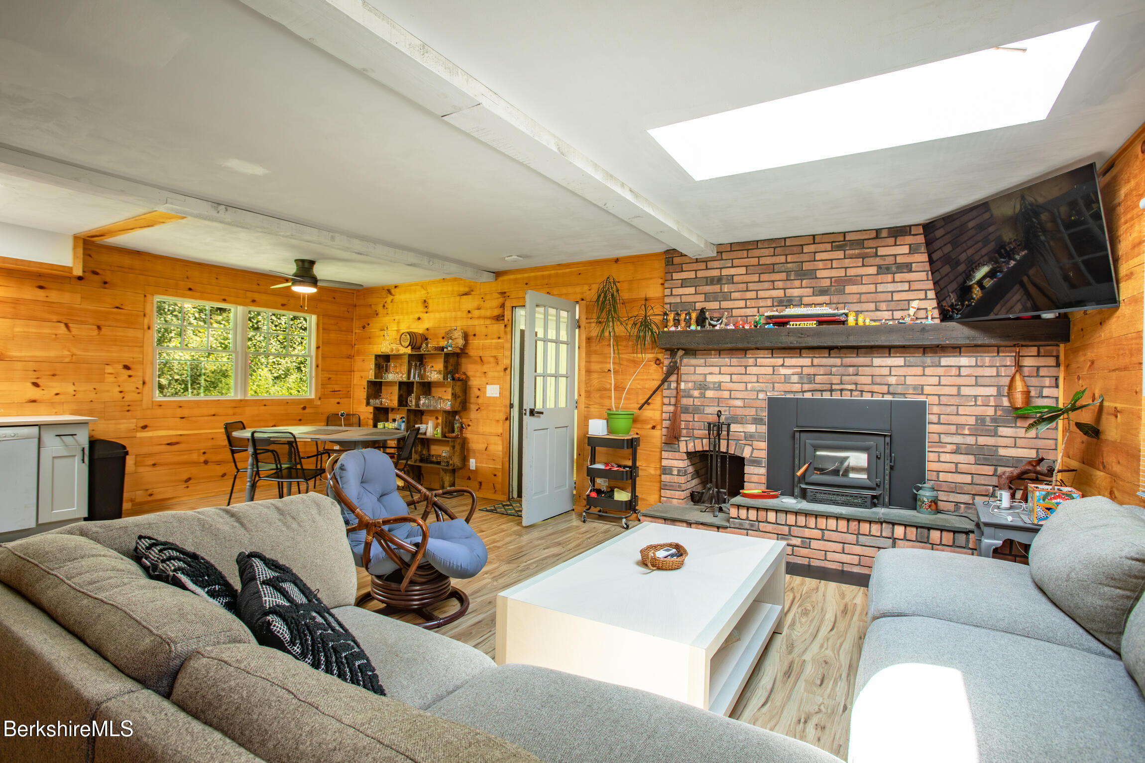 50 Beach Road Becket, MA 01223 - Photo 9 of 31 a living room with furniture a fireplace and floor to ceiling window