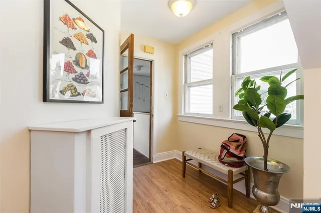 a view of a workspace with furniture and a potted plant