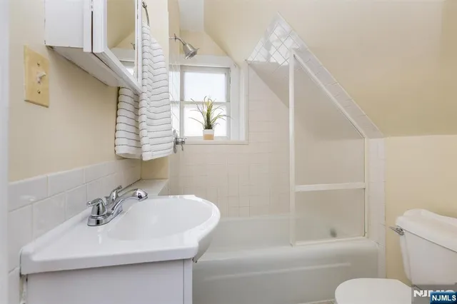 a bathroom with a sink a toilet and a bathtub