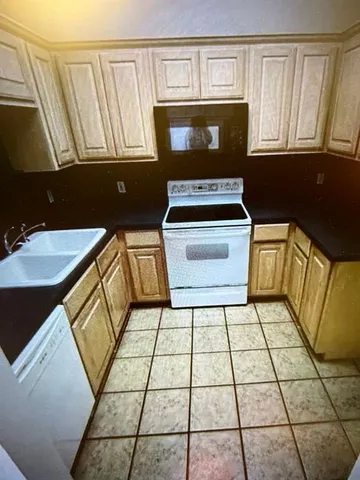 a kitchen with a stove a sink and a microwave