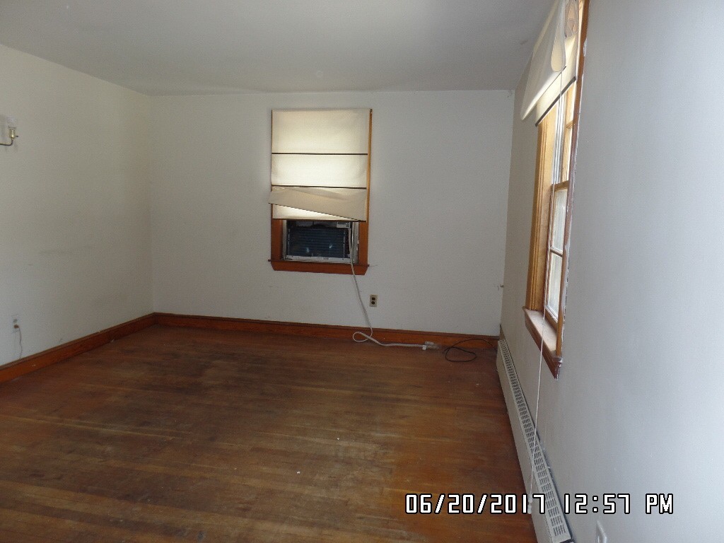 58 Baldwin Road Billerica, MA 01821 - Photo 10 of 15 a view of an empty room with wooden floor and a window