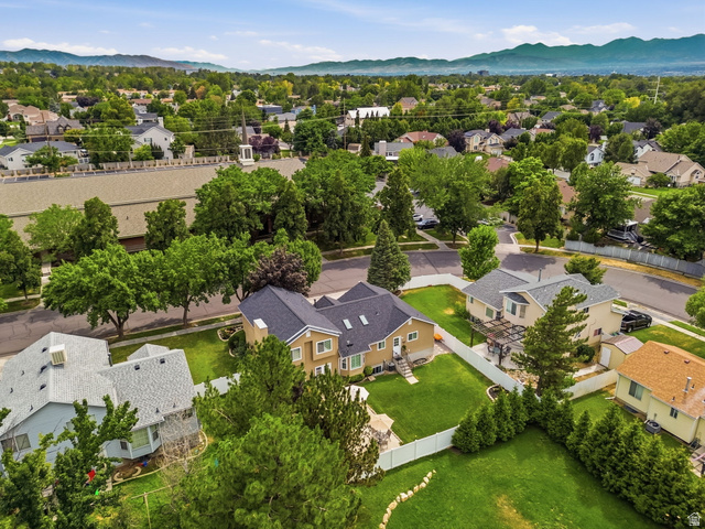 1101 Old Dairy Road Sandy, UT 84094 - Photo 36 of 36 Aerial perspective showcasing a residential street with mature trees and mountain scenery
