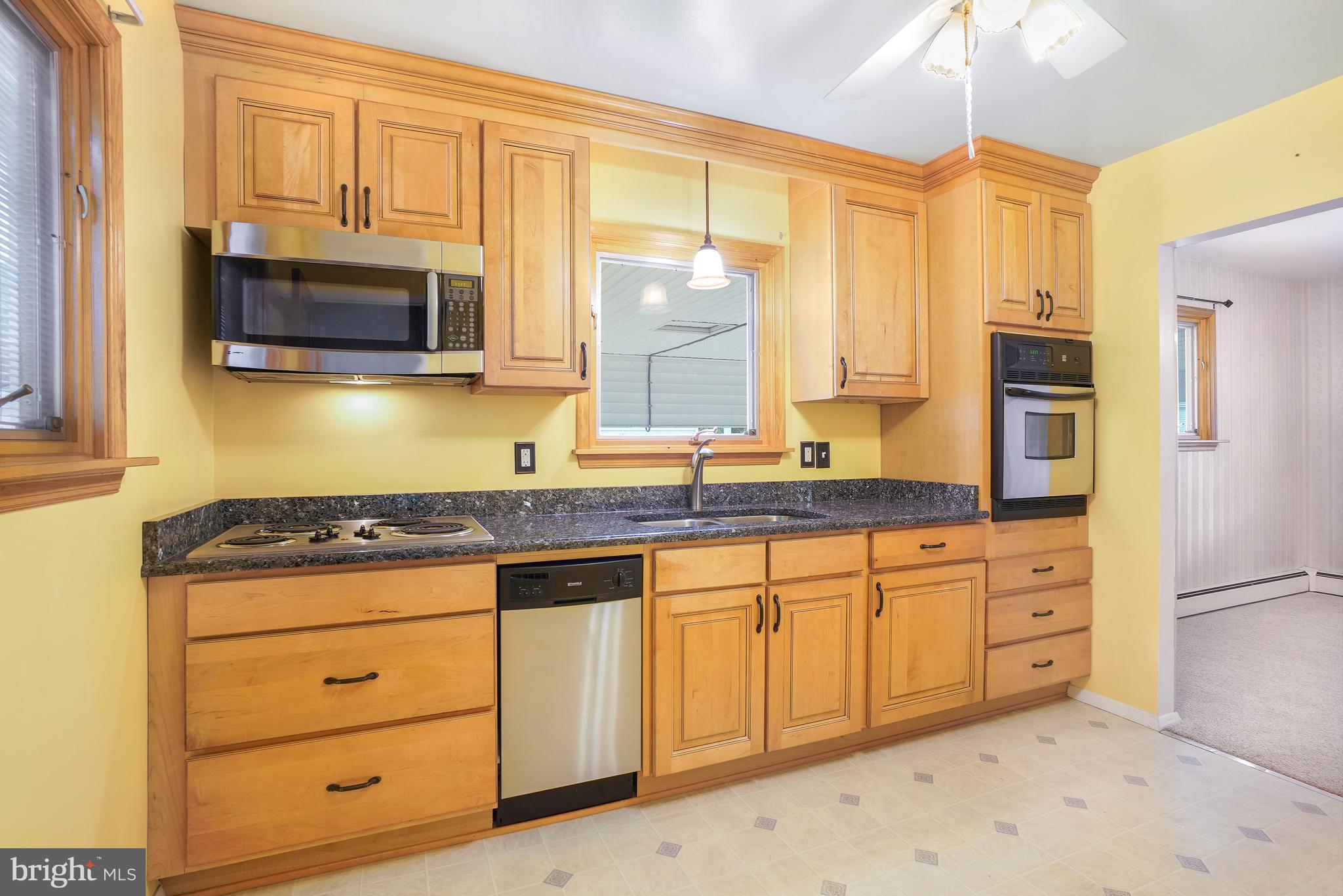 1403 Disney Road Severn, MD 21144 - Photo 14 of 39 a kitchen with granite countertop cabinets stainless steel appliances a sink and a window