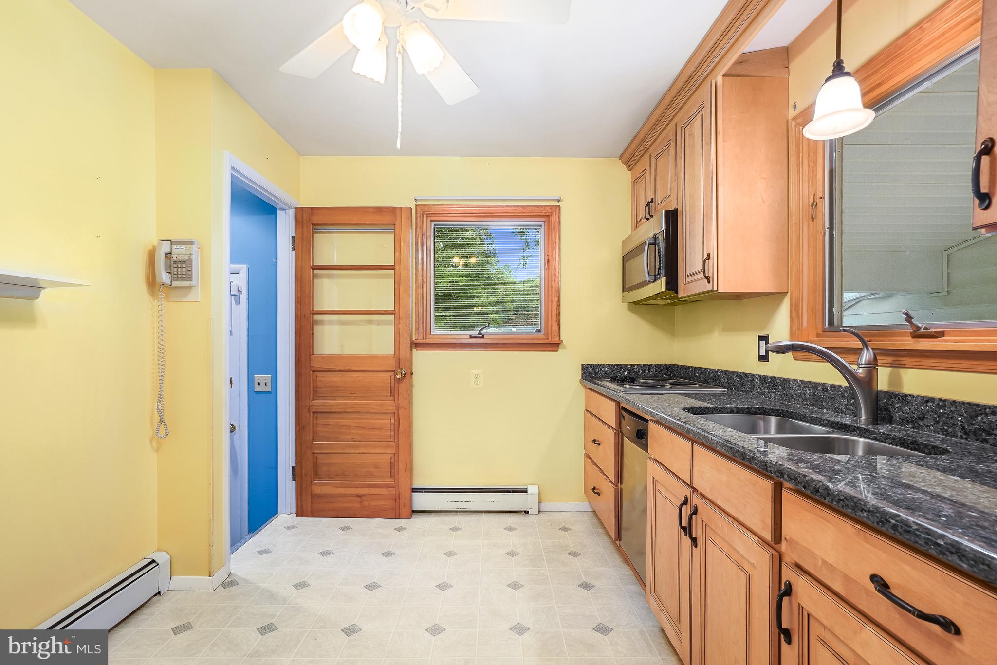1403 Disney Road Severn, MD 21144 - Photo 15 of 39 a kitchen with granite countertop a sink and a refrigerator