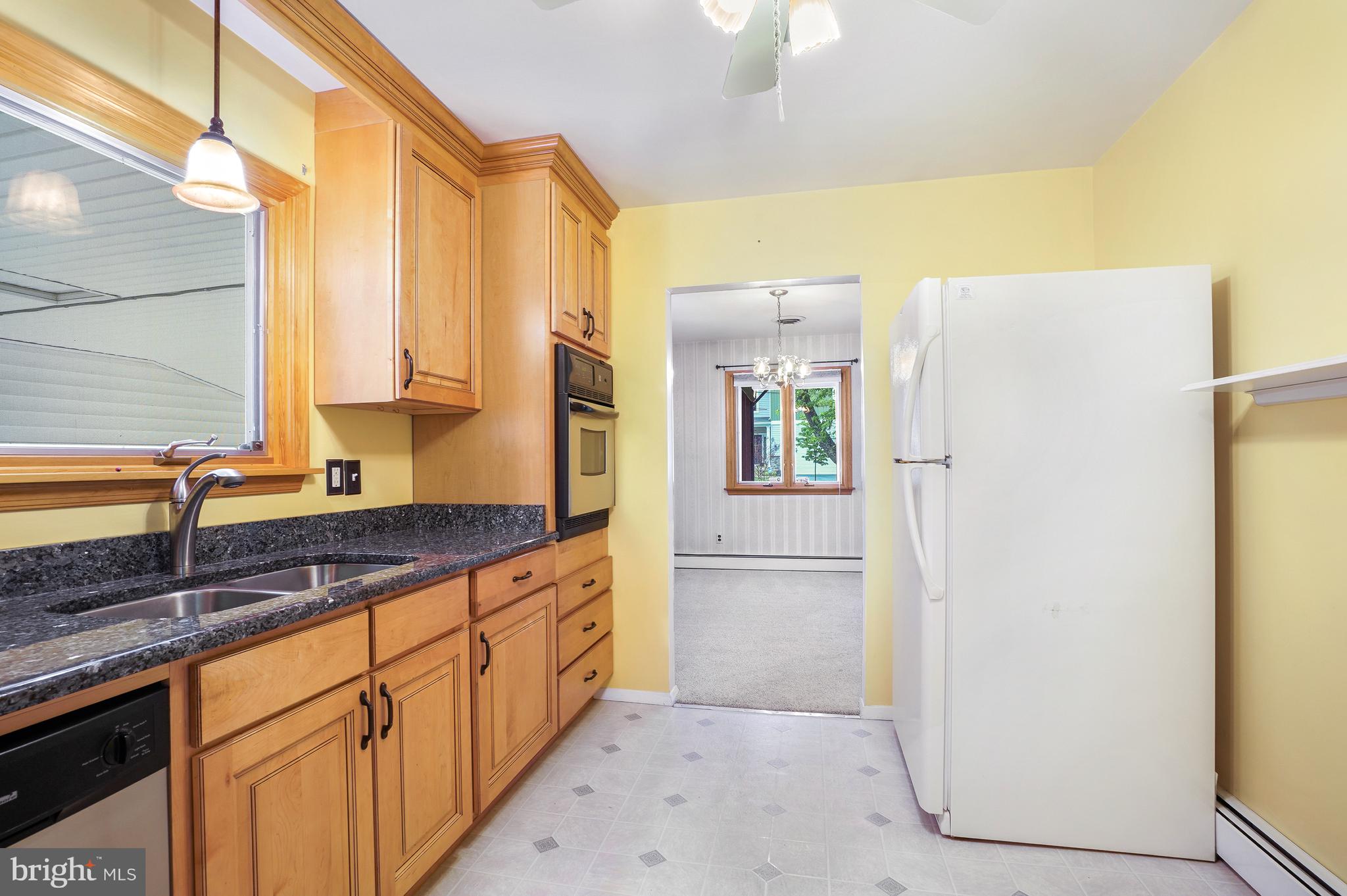 1403 Disney Road Severn, MD 21144 - Photo 16 of 39 a kitchen with stainless steel appliances granite countertop a refrigerator and a sink